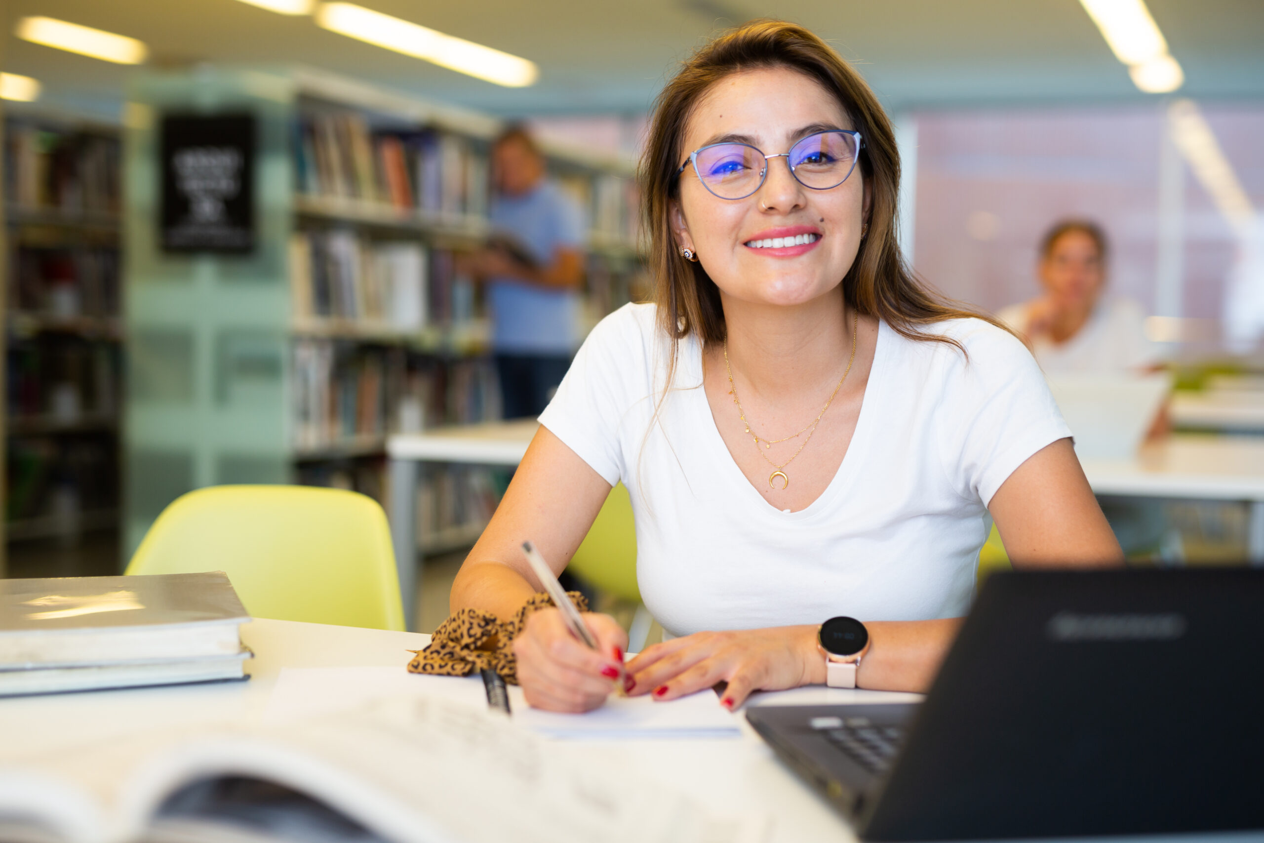 Une étudiante révise ses examens dans une bibliothèque